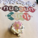 Musuemcamp badges and a decorated cupcake